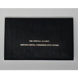 the official olympic precious metal commemorative black album with the 1 and 2